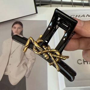 Saint Laurent Cassandre Shark Hair Clip In PVC and Steel with Bamboo Logo Black